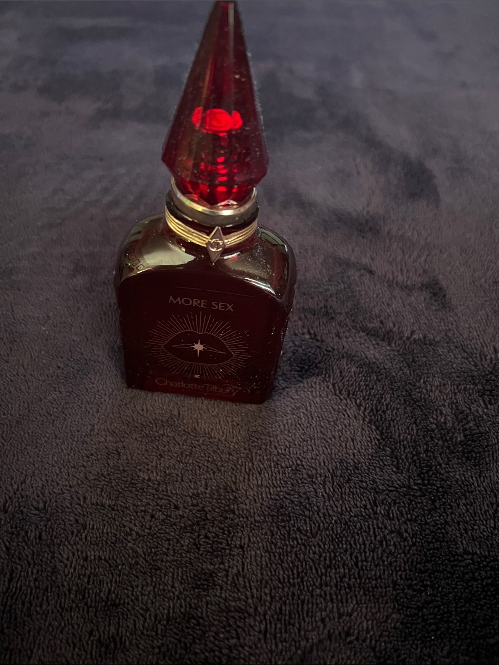 Charlotte Tilbury More Sex Perfume Bottle in Ruby Red with Gold Accents